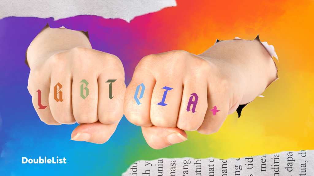 DoubleList graphic of two fists with the LGBTQIA+ anagram on each knuckle, punching through rainbow paper to symbolize gay dating.